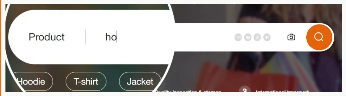 A close-up of a rounded search box with the word Product at the left, the letters h o typed in the middle, four small grey platform badges and a camera icon towards the right, a round orange magnifier button on the end, and three shortcut pills reading Hoodie, T-shirt and Jacket underneath